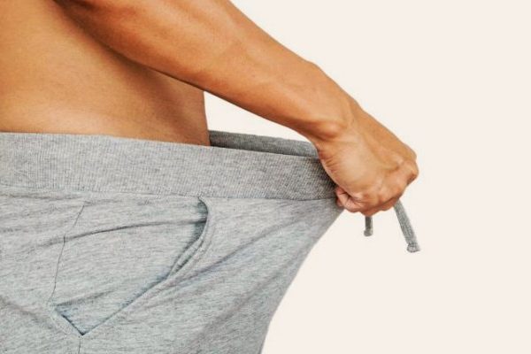 man pulling his pants out