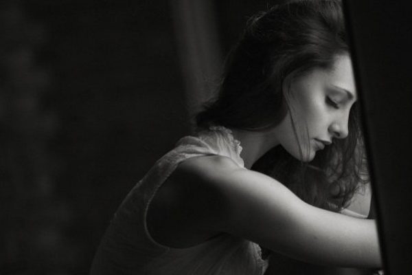 sad lady standing near window