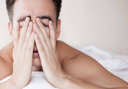 sad-man-hiding-his-face-under-hands