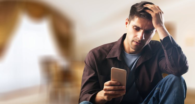 irritated man checking phone