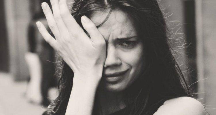Black and white close up of woman crying