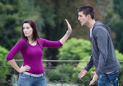 lady pushing man away