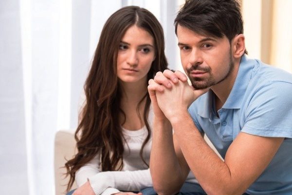 Upset woman looking at her boyfriend