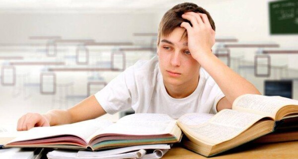 a sad student at his study desk