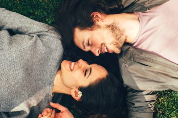 couple lying on the grass