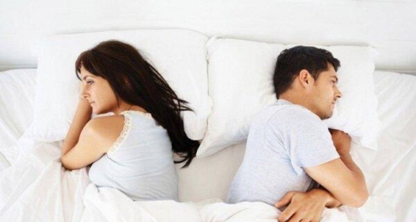couple not talking to each other in bed
