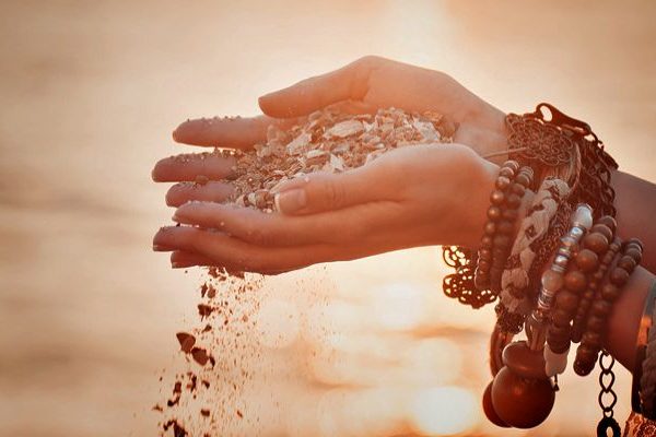 lady hands with full of sand