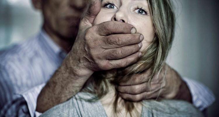 man chocking woman's mouth