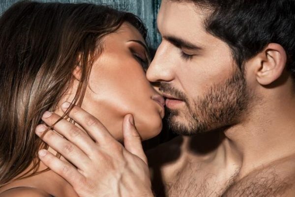 man kissing naked woman