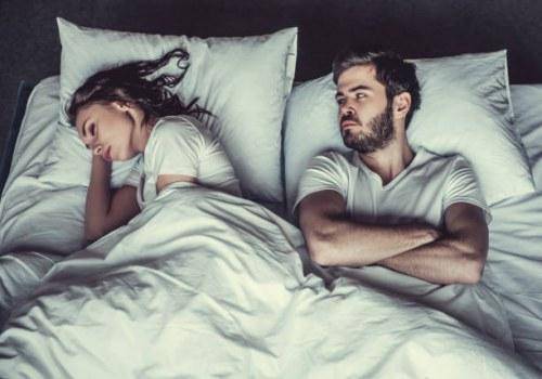 man looking woman in bed