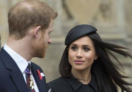 Meghan in black dress with harry