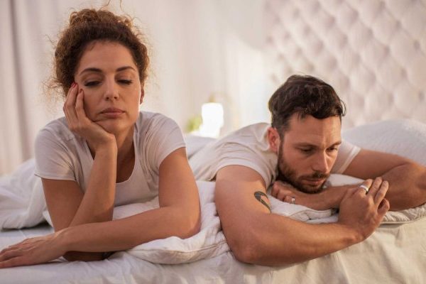 sad couple not talking in bed