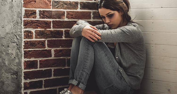 abused woman sitting on the floor