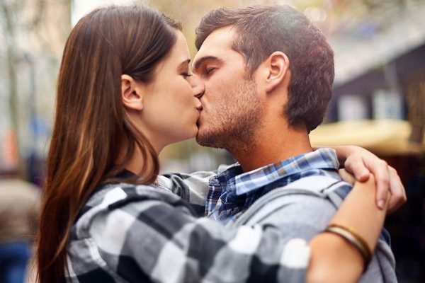 couple kissing and hugging in public