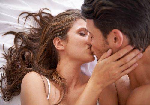couple kissing in bed