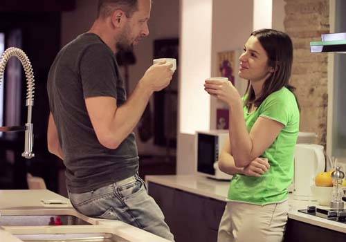 happy couple talking in kitchen