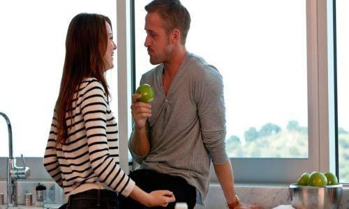 man and woman enjoying together in kitchen