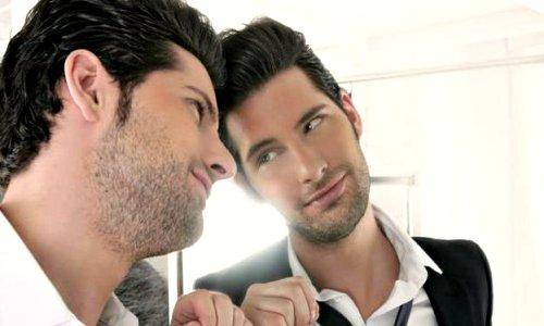 man checking own self into mirror