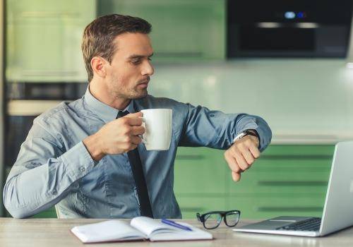 man checking watch in office