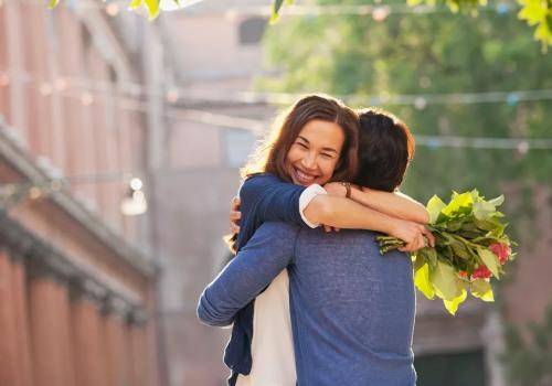 man giving flowers to woman