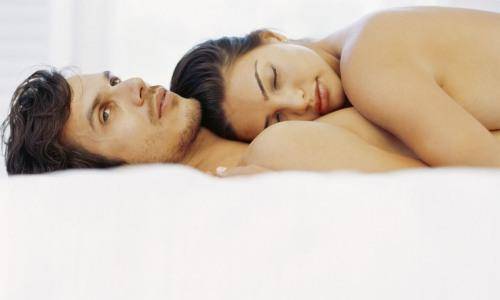 sad man and woman in bed