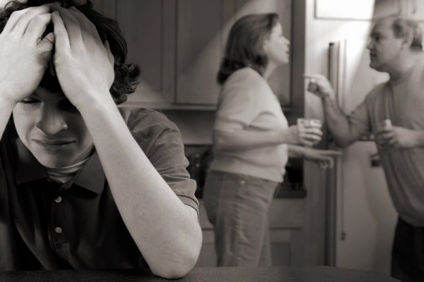 sad man crying behind the parents
