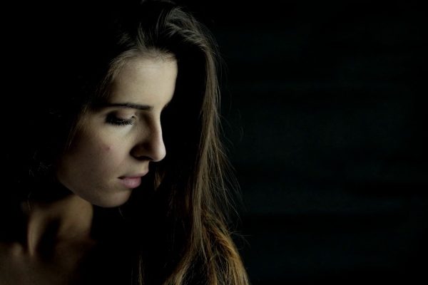 sad woman in black background
