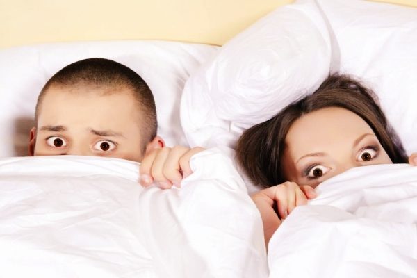 shocked couple in bed
