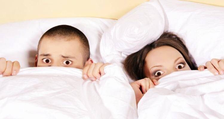 shocked couple in bed
