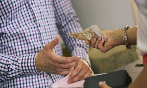 woman giving man money