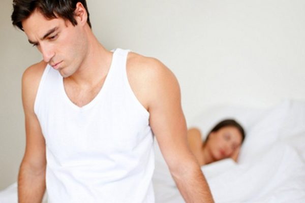 worried man sitting on the bed
