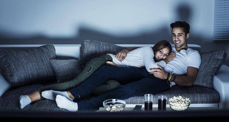 happy couple watching television