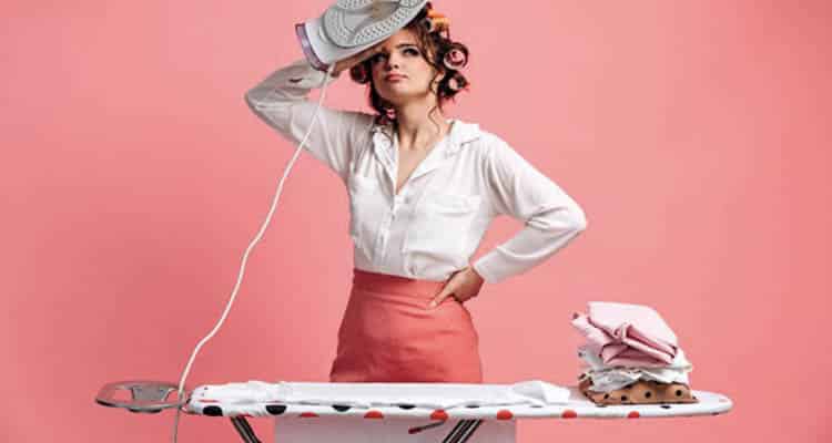 Woman ironing clothes on ironing board