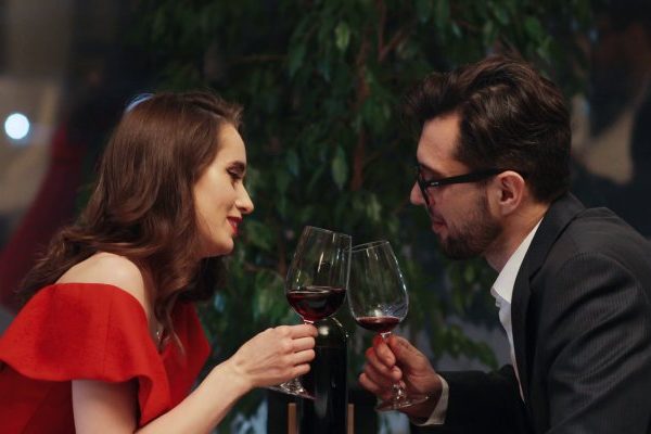 man and woman drinking wine