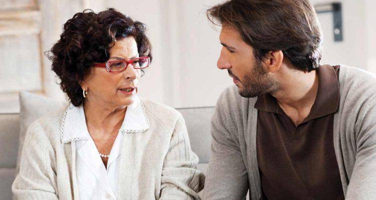 man talking with mother. You need to tell your parents about your divorce and prepare them in advance