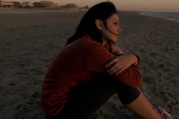 sad indian woman at the beach
