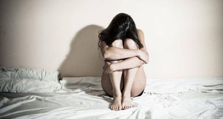 sad woman in bed coming
