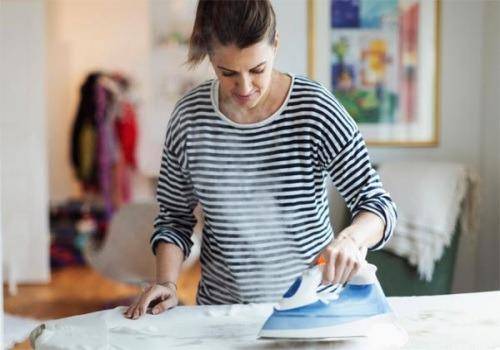 woman ironing shirt