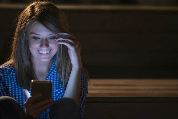 woman laughing while chating
