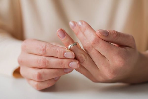 woman removing ring from finger