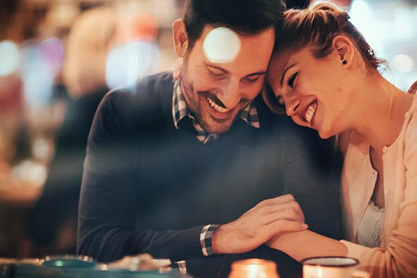 man and woman laughing in hotel