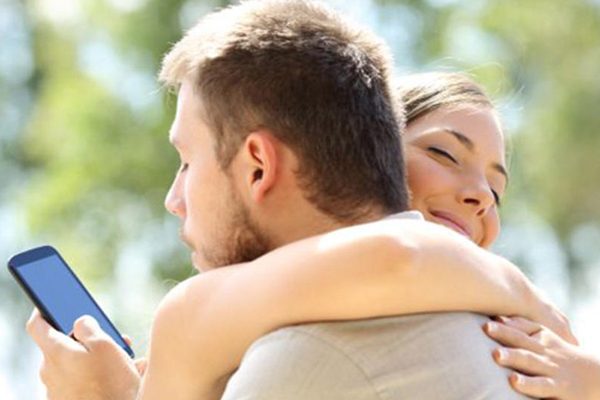 man and woman using phone
