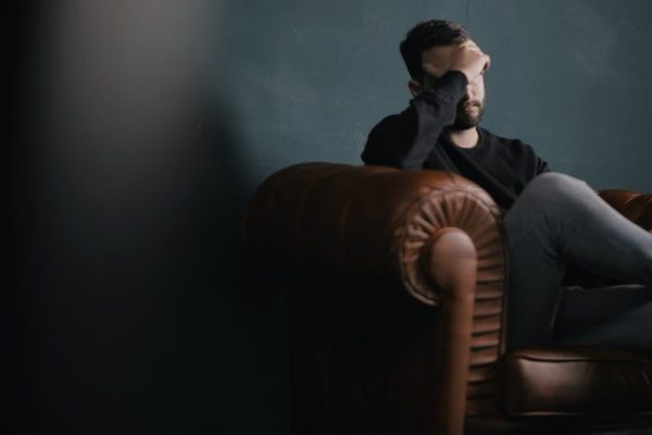 man sitting on sofa and thinking