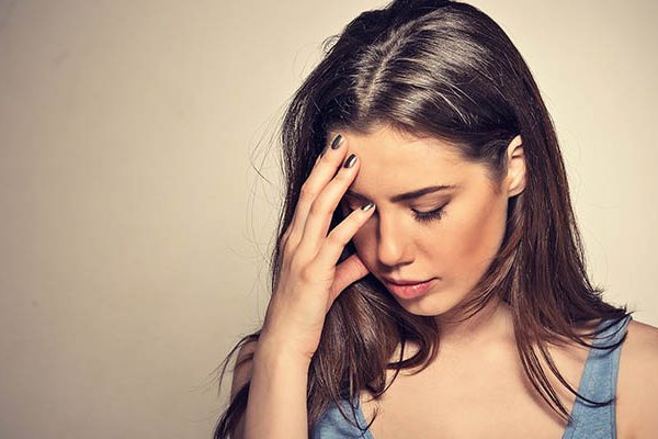 woman crying hiding ger face