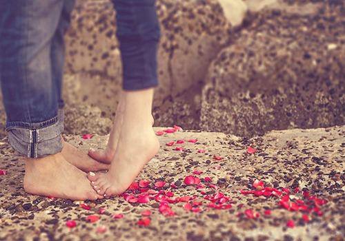 Feet of couple kissing