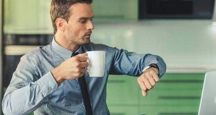 Man checking watch in office