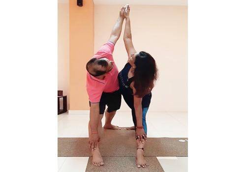 Yoga asana'Partner Triangle Pose ' helps in deepening the posture