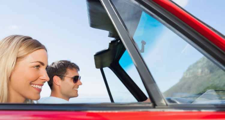 couple taking selfie while going for drive