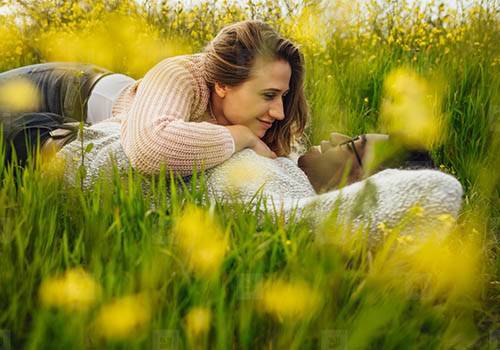 Happy couple lying on grass