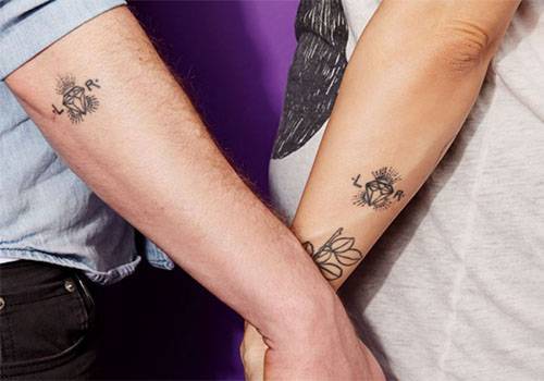 tattoo in couple hand